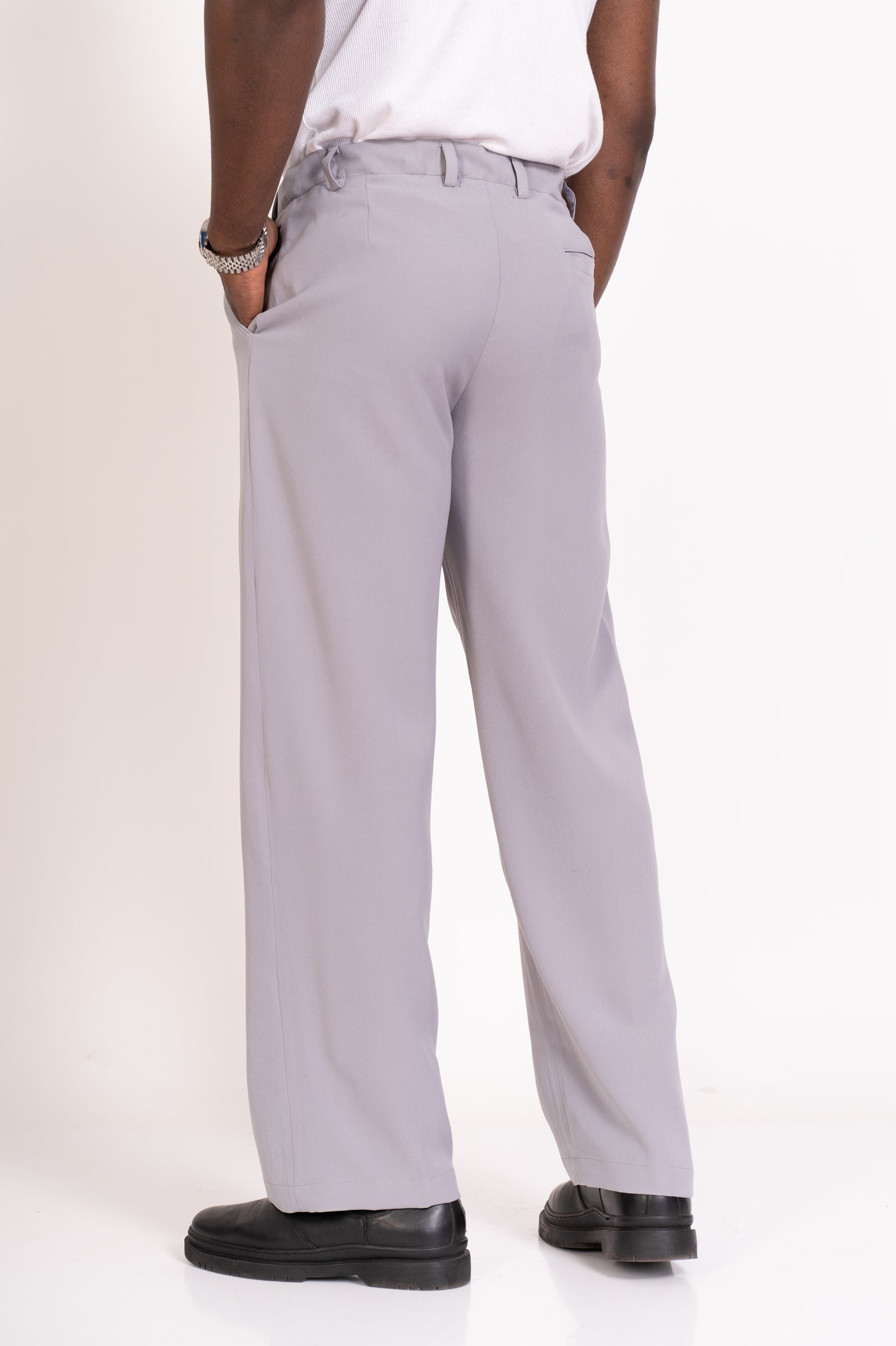 Person wearing strada light grey pants on a white background