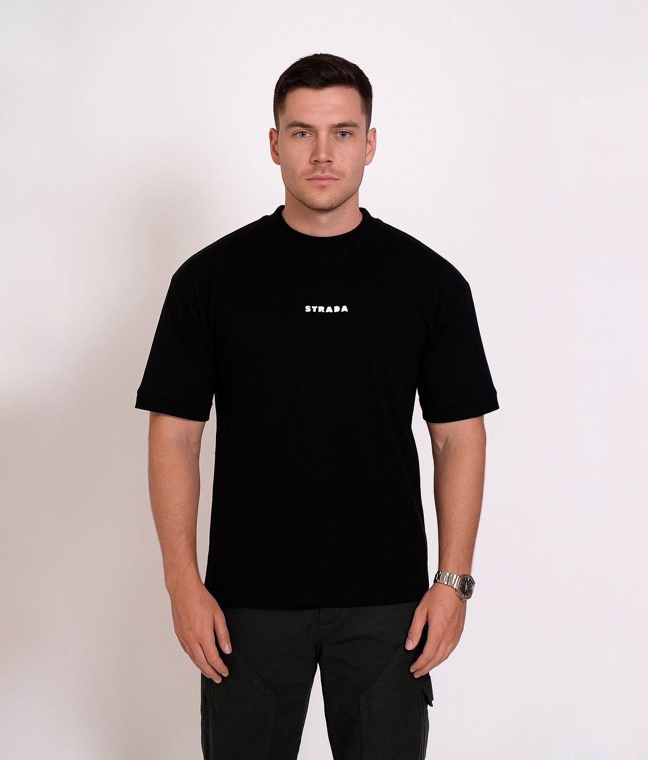 Man wearing strada abstract black oversized t-shirt with a logo on a white background
