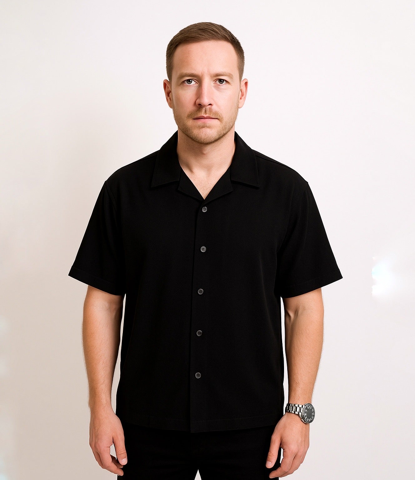 Man wearing strada bowling club black short-sleeve shirt against a plain background