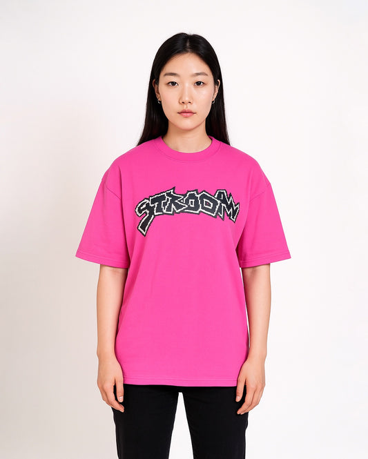 Person wearing STRADA Error Glitch Oversized Crew Neck bright pink t-shirt with a logo on a plain background