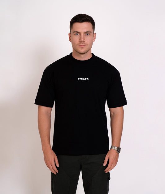 Man wearing strada abstract black oversized t-shirt with a logo on a white background